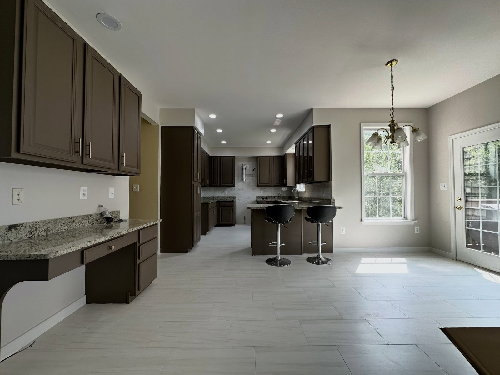 The same kitchen finished: refinished cabinets, new tile