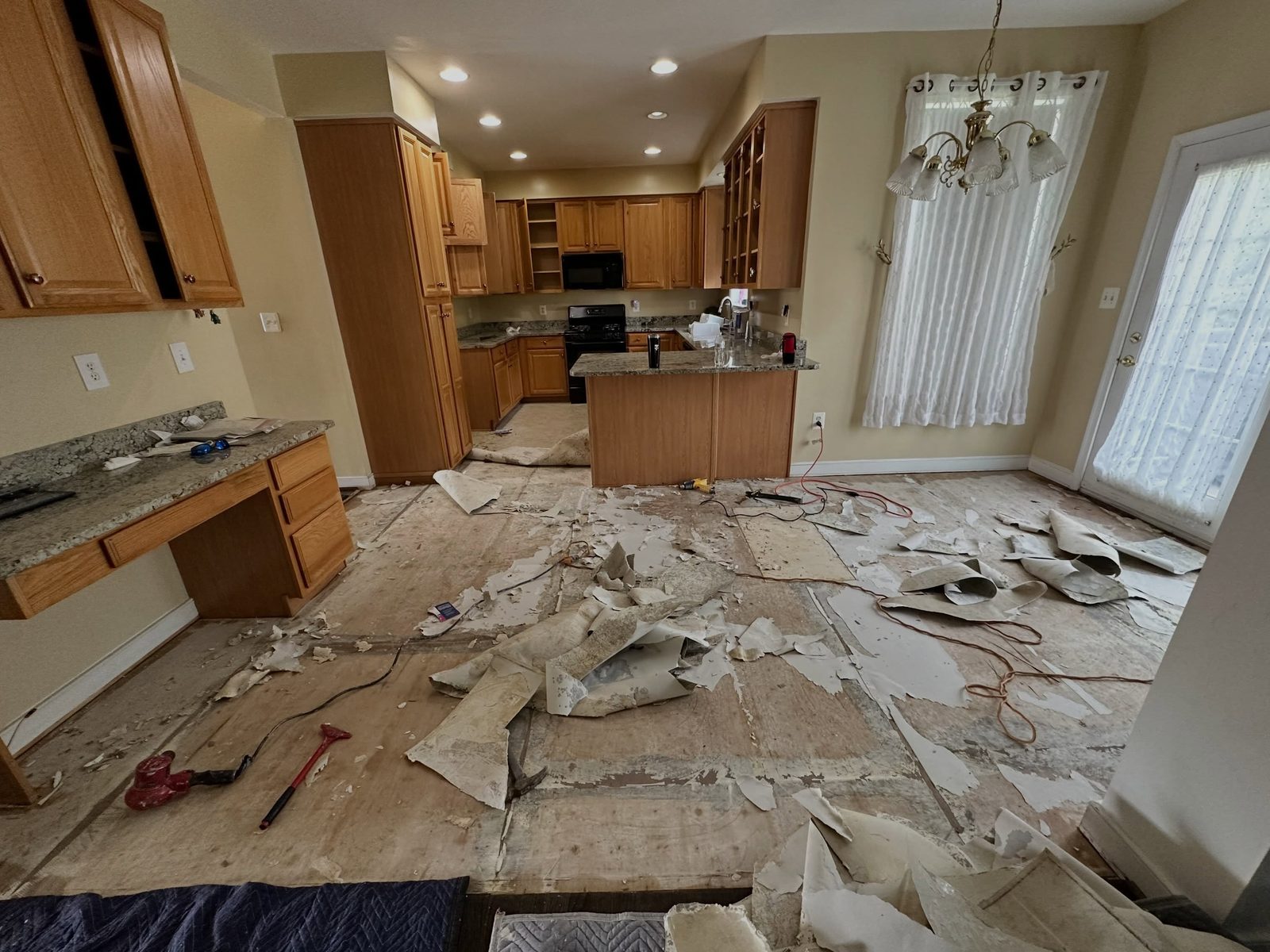 Kitchen before: oak cabinets, floor demoed